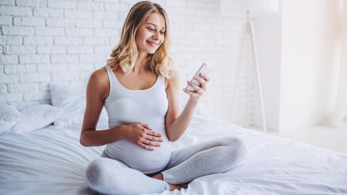 Pregnant in bed.