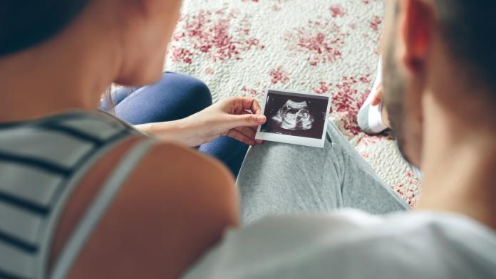 Couple looking at ultrasound of their baby