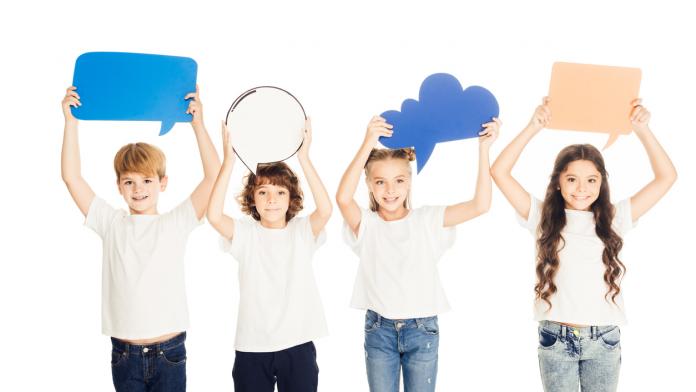 adorable children holding paper speech bubbles above heads isolated on white