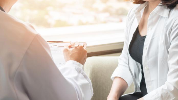 Doctor (obstetrician, gynecologist or psychiatrist) consulting and diagnostic examining female patient's on womanâ??s obstetric - gynecological health in medical clinic or hospital healthcare service center