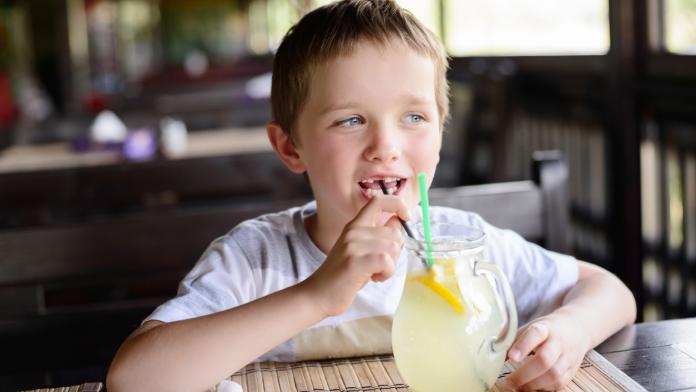 Little child boy enjoying his delicious lemonade DIY limonade