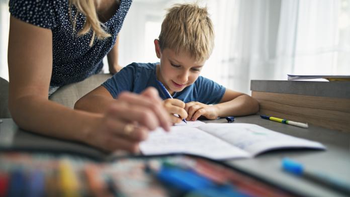 Mother helping son to do his homework