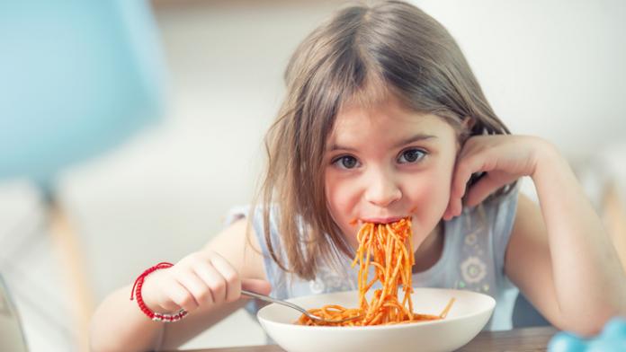 Cute little kid girl eating spaghetti bolognese at home. spaghetti