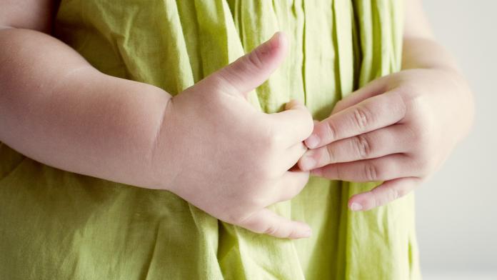 Child putting hands on stomach glutenallergie of glutenintolerantie