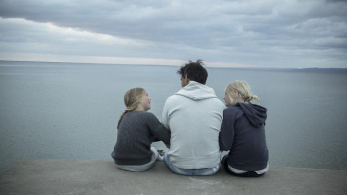 Father with daughters at sea vader ziekte