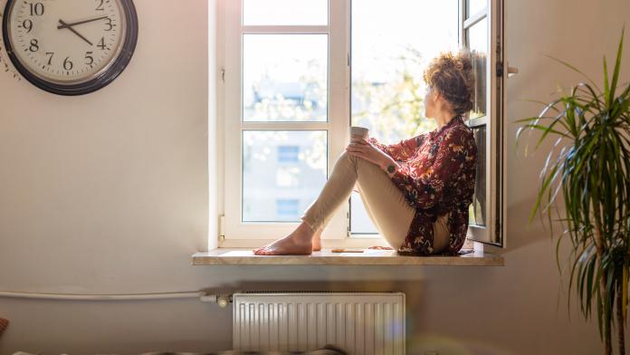 Young woman looking out of window