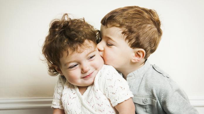 Little boy kissing little girl.
