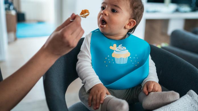 Mother feeding her baby boy