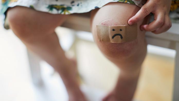 Child with a plaster on her knee
