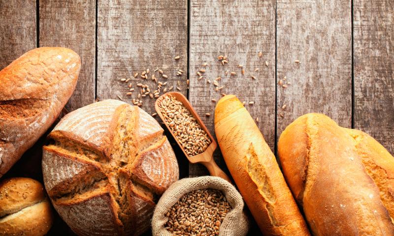 Assortment of baked bread on wooden table background; Shutterstock ID 278970809