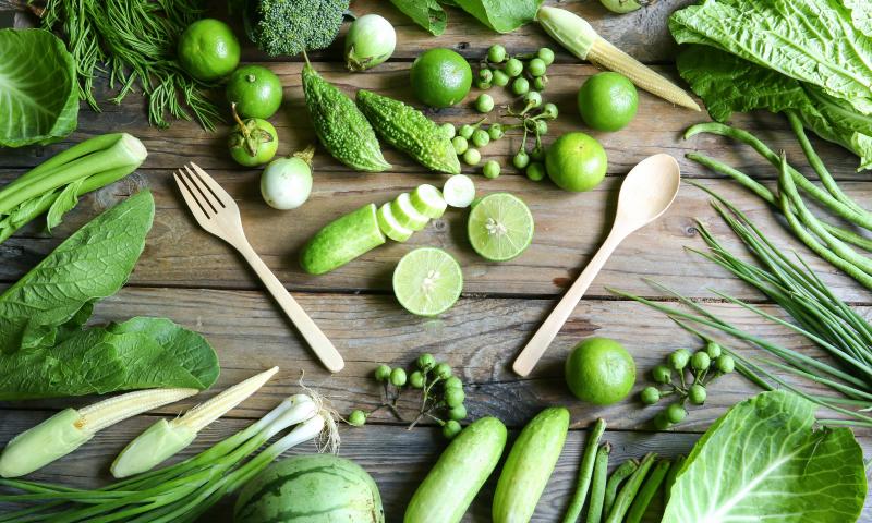 fresh organic green vegetables fork and spoon on wooden floor with copy space. concept Eat Healthy; Shutterstock ID 454533415
