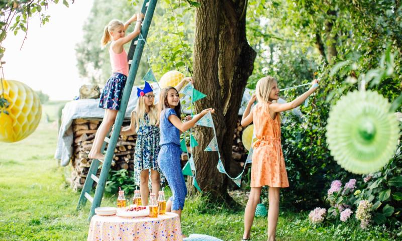Girls decorating garden for summer party