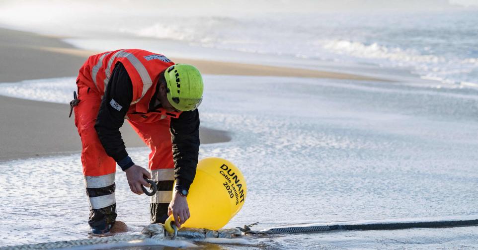 File photo dated March 13, 2020 of technicians working on the landing of Googles Atlantic sub-marine cable, called Dunant, in Saint-Hilaire de Riez, western France. Dunant is a private 6,600 kilometre transatlantic communications cable that connects the United States (Virginia Beach) with France (Saint-Hilaire-de-Riez). It was announced by Google in 2018 and is due to go live in 2020.In July 2018, Google announced that it would be investing in two private subsea cables - Dunant and Curie - both of which were named after Nobel prize winners. Google claimed that it was the first 