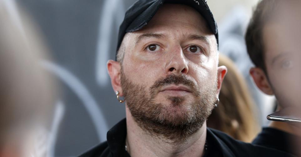 Fashion designer for Vetements, Demna Gvasalia talks to people at the end of his men and women's Spring/Summer 2019 collection fashion show, in Paris, on July 1, 2018. (Photo by GEOFFROY VAN DER HASSELT / AFP) (Photo by GEOFFROY VAN DER HASSELT/AFP via Getty Images)
