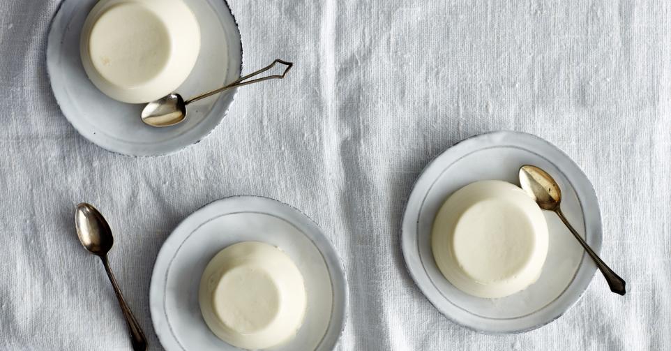Overhead view of panna cotta desserts on saucers