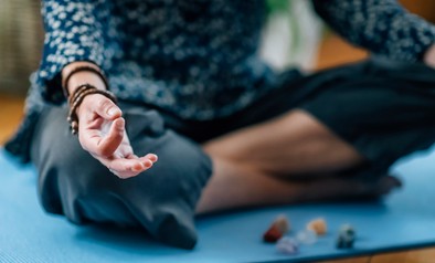 Low Section Of Woman Meditating At Home